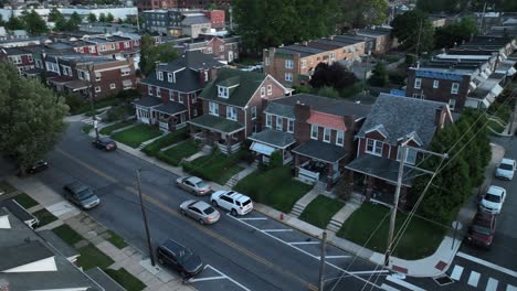 Car-turning-on-city-street-among-houses-and-homes-in-urban-area-in-USA-at-night