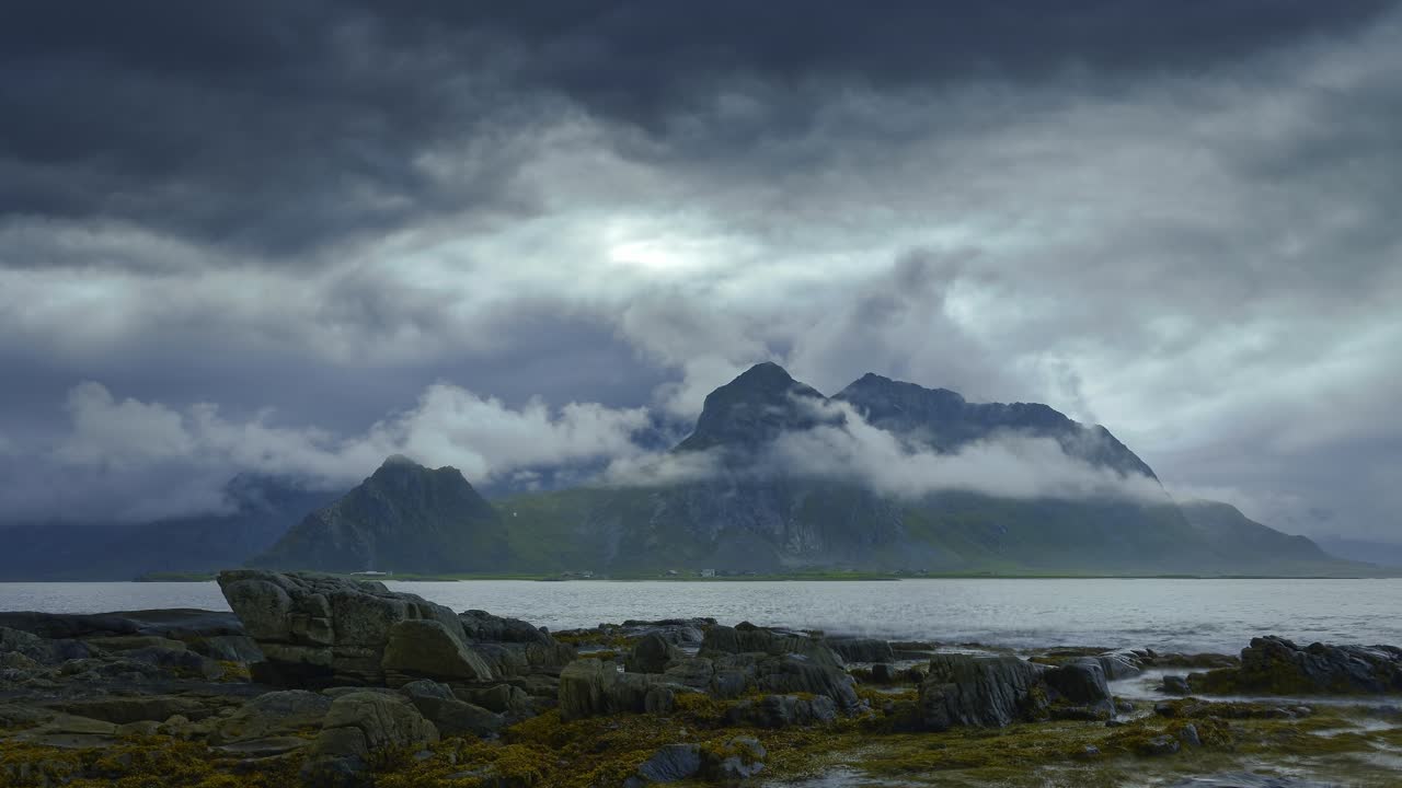 Darkening storm clouds approaching the bay and surrounding mountains