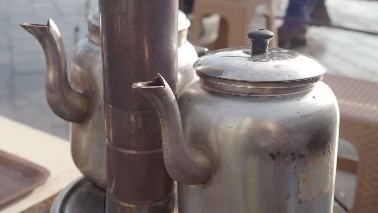 Close-up of a steaming metal teapot
