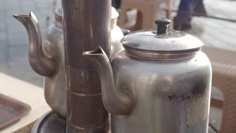 close-up of a steaming metal teapot