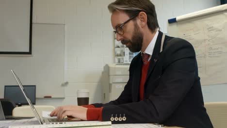 businessman using laptop at desk 4k