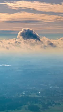 high altitude timelapse mid level clouds over rural agriculture field countryside, vertical video