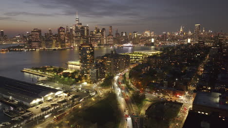 aerial view of brooklyn, manhattan, and the east river at night. shot in new york city.