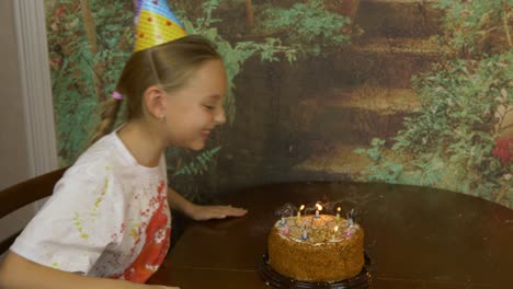 funny girl and her father can not blow birthday candles on cake. joke party at home. young girl with adult man blowing candles on cake. lot of smoke and ash on table. girl clapping. fast motion effect