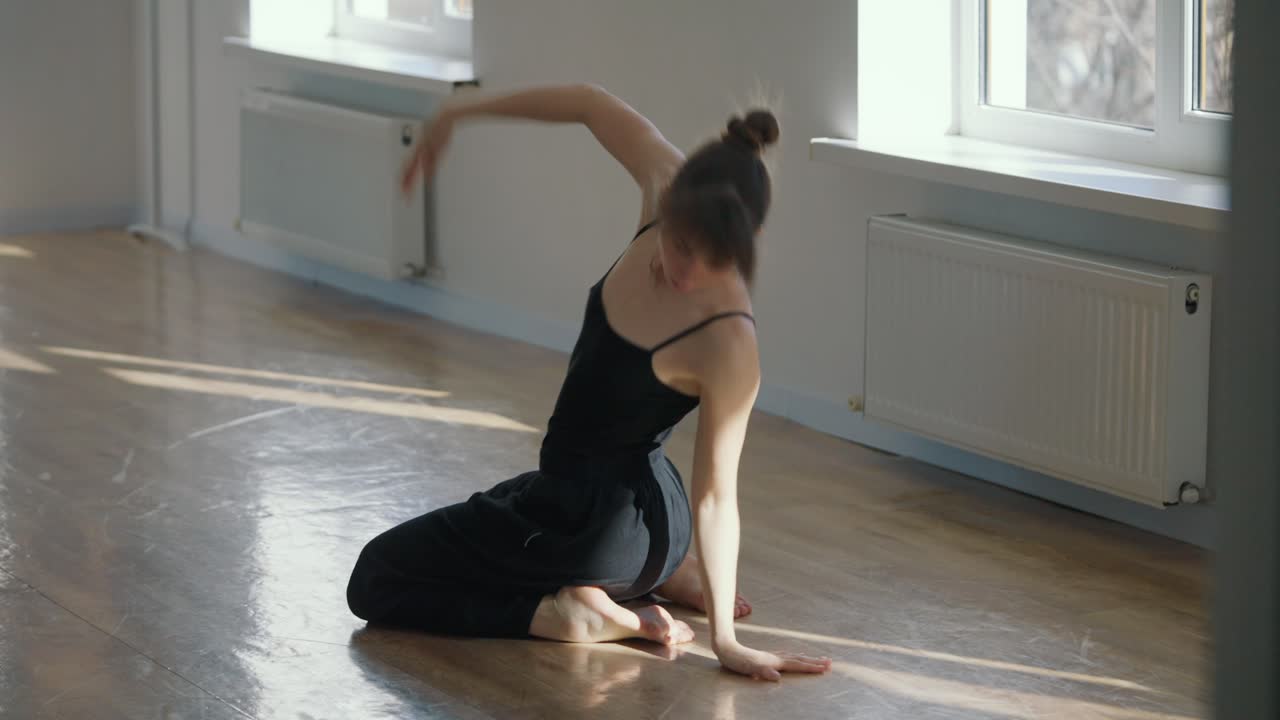 A woman dancing gracefully indoors