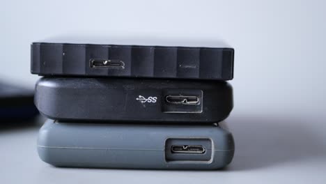 stack of external hard drives on table