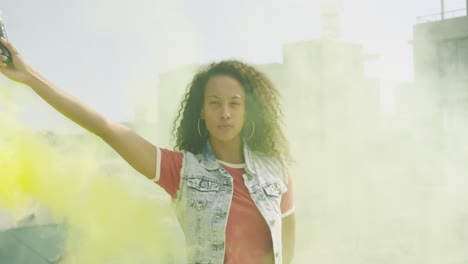 Fashionable-young-woman-on-urban-rooftop-using-a-smoke-grenade