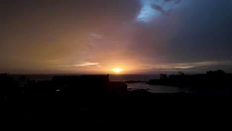 a mesmerizing sunset over the ocean at galle fort, sri lanka, with vibrant colors illuminating the horizon, creating a tranquil atmosphere.