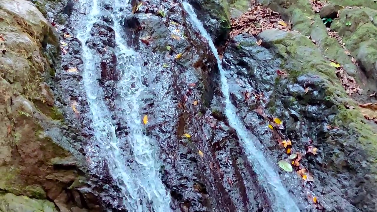 A magnificent waterfall cascading with sheer power and grace. water rushes down, creating a mesmerizing display of nature's raw power.