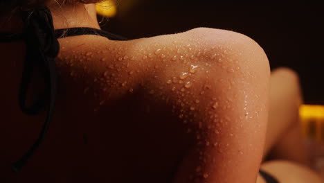 woman's back covered with sweat drops