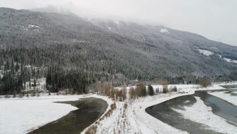 Snow-covered-land-and-mountains-along-the-river-4k