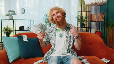 successful happy rich business man counting money cheering up with high profits lottery game win