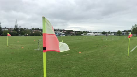 Red-and-yellow-flag-waving-in-the-wind-at-football-ground-during-the-day-in-Auckland-New-Zealand