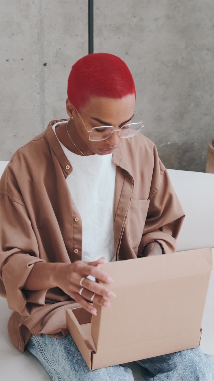 Unboxing a surprise package in a stylish modern space