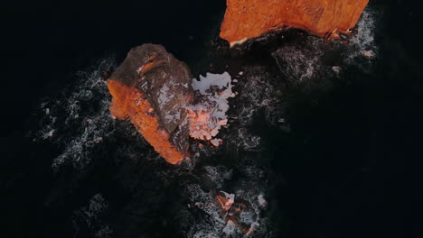 Drone-top-down-view-at-60fps-of-famous-Perce-rock-in-Percé,-Québec,-Canada