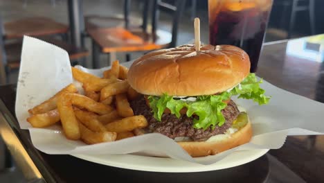 Juicy-freshly-made-hamburger-with-fries-at-a-diner---isolated