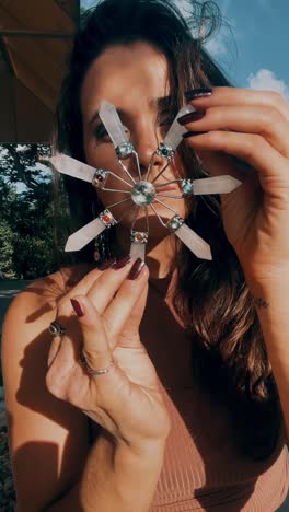 woman holding a crystal grid