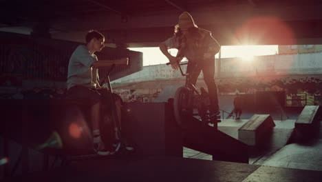 sporty teens practicing together at skatepark. active people giving five.