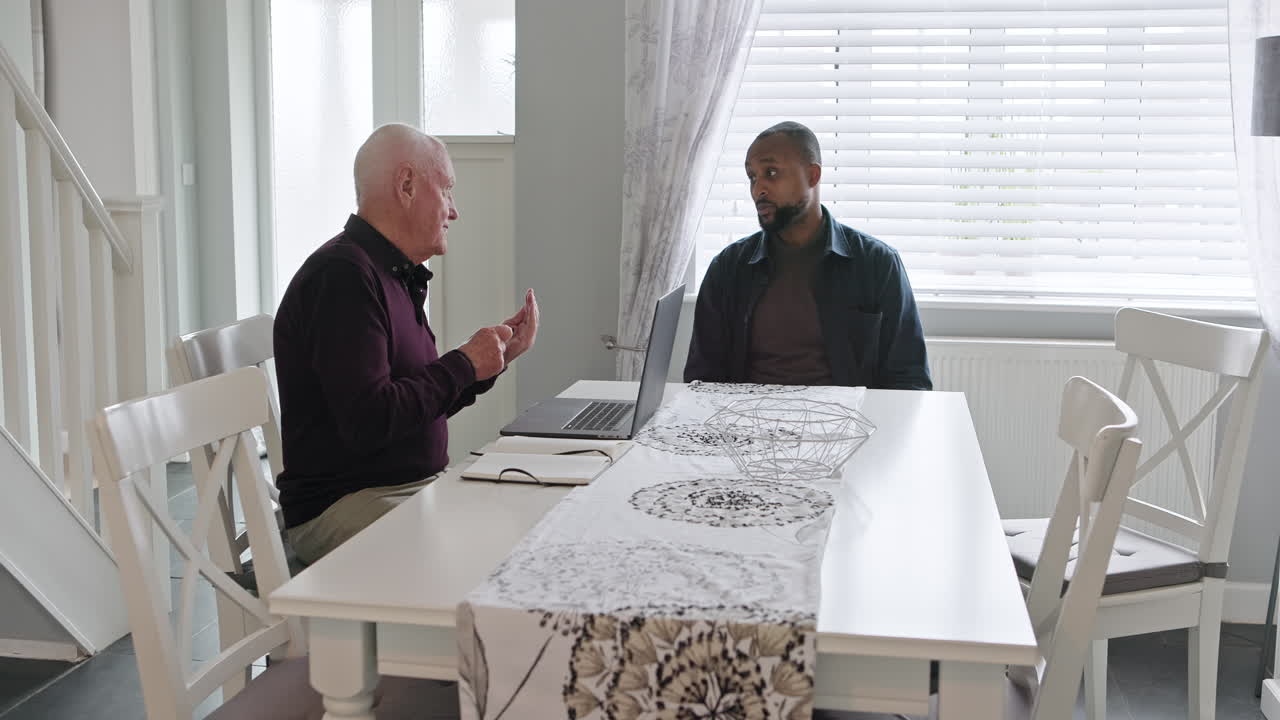 Two men having a conversation at a table