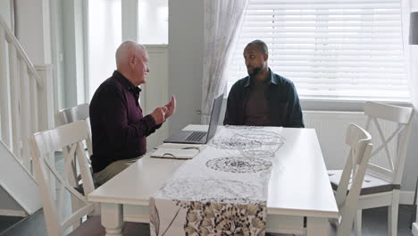 two men having a conversation at a table