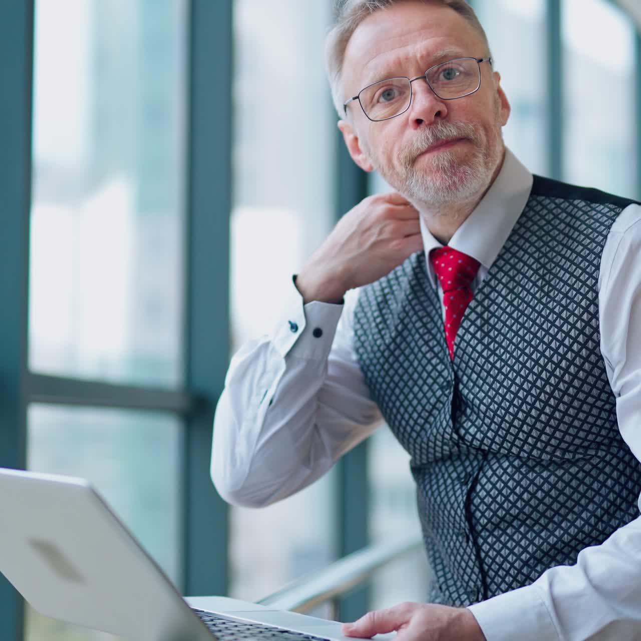 . Businessman Using Laptop. Handsome businessman working on laptop in cafe