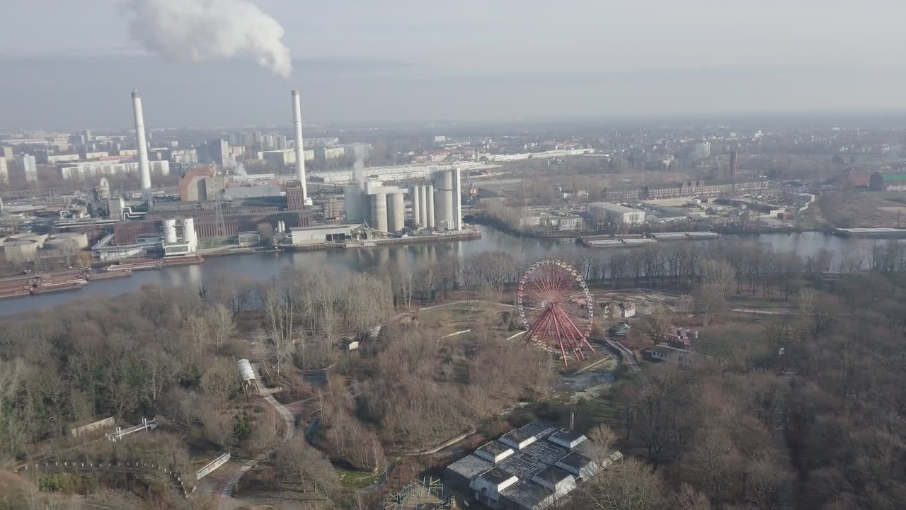 Aerial View of Abandoned Amusement Park next to Industrial Factory