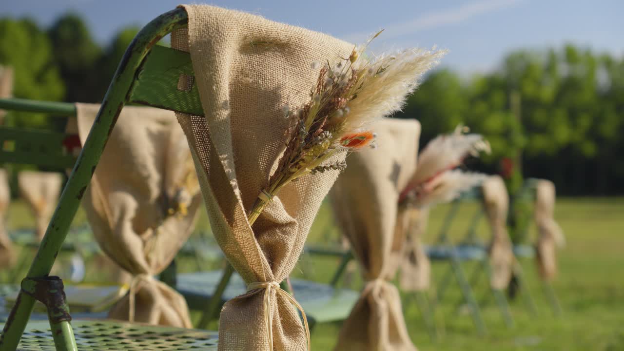 Rustic Wedding Ceremony Decor: Burlap-Wrapped Chairs with Dried Flower Arrangements