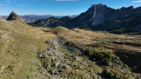 high mountain valley with lake and road