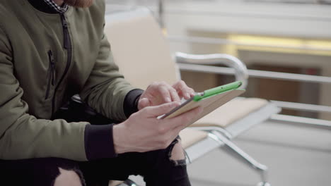 man using tablet at the airport