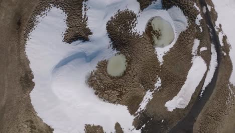 Top-Down-Aerial-View-of-Snow-and-Ice-in-Inactive-Volcano-Crater,-Iceland