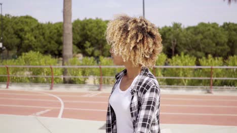 One-young-female-skater-walking-with-board-in-hand