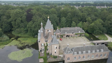 jib up of beautiful mansion surrounded by water and trees