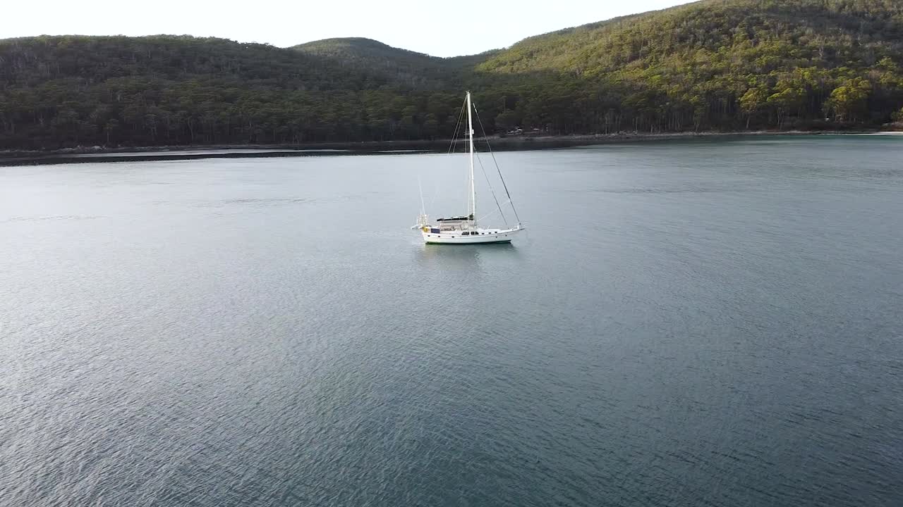 Sailboat at Sunset on Calm Ocean