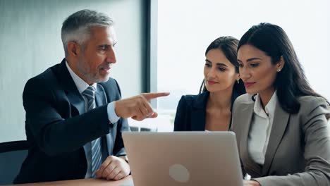 business people working on a laptop in a meeting room