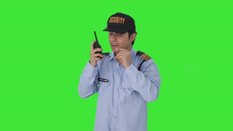 Angry-Indian-security-guard-giving-instructions-on-walkie-talkie-Green-screen