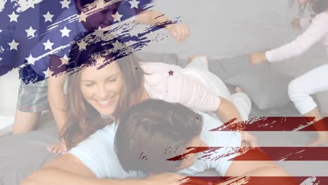 animation of u.s. flag drawing, red and blue stars floating over caucasian family playing in bed