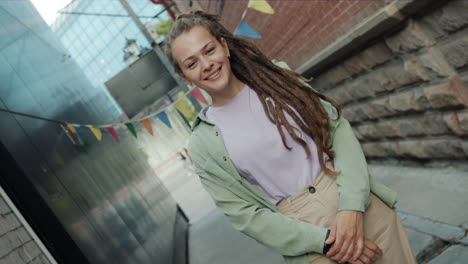 young woman with dreadlocks in urban setting
