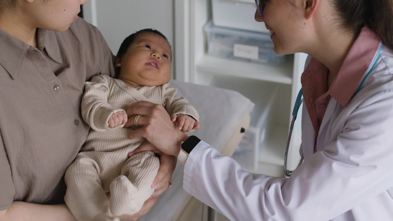 A baby getting a checkup by a doctor