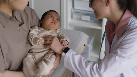 a baby getting a checkup by a doctor