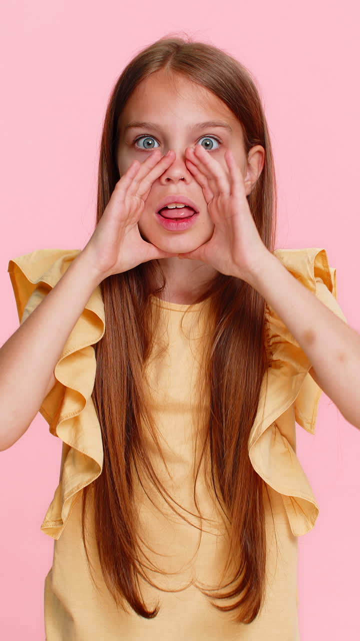 Child girl kid screaming with hands around mouth pretending to use loudspeaker call someone loudly