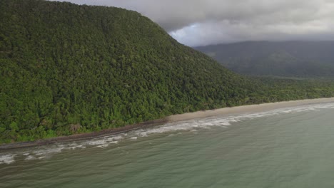 scenic beach and mountains at daintree national park in far north queensland, australia - aerial drone shot