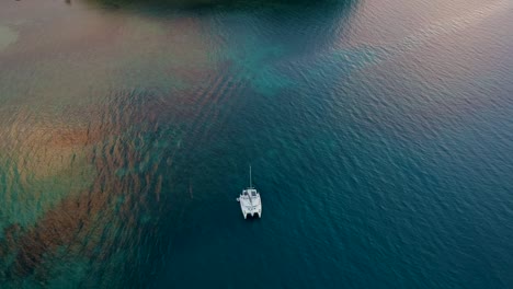 Aerial-reveal-of-sunset-at-Las-Cabanas-beach,-El-Nido,-Palawan,-Philippines