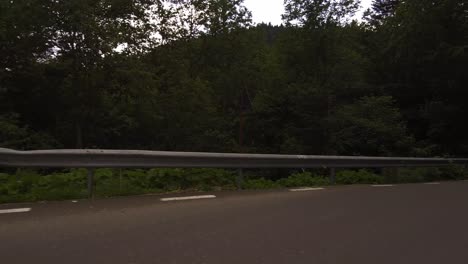 Drive-down-the-mountain-on-a-narrow-and-winding-road-during-sunset,-Bucegi-mountains,-Romania