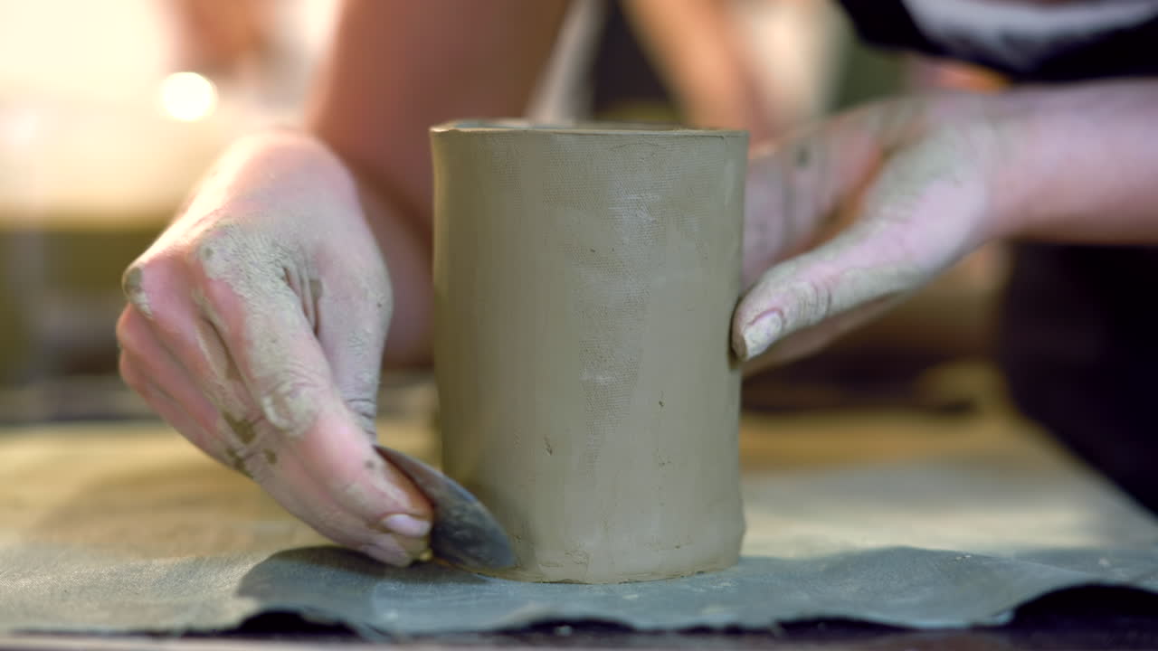 Students modelling clay into cups
