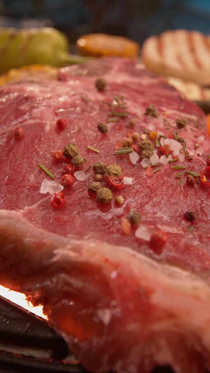 Beef steak grilling with pepper and salt