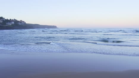 spanish resort playa de isla from secluded beach at sunset low drone orbital