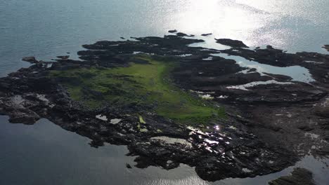 aerial view looking down onto a rocky outcrop on the scottish west coast