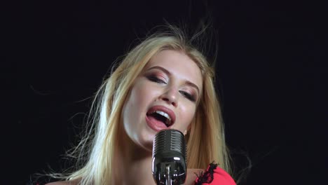 woman singing into retro microphone