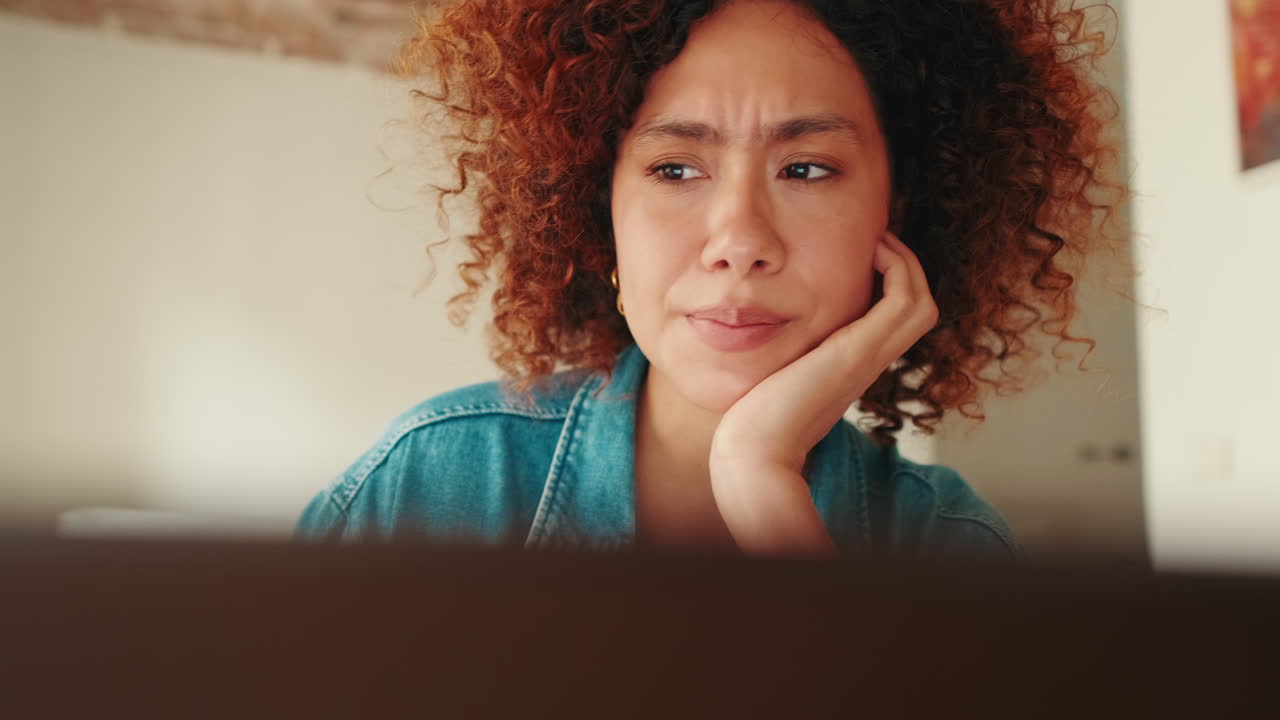 Focused Young Woman Listening Intently to Laptop Screen