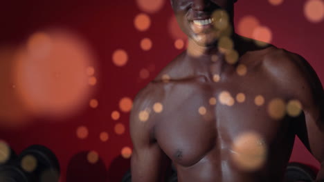 bokeh light animation over muscular man holding protein powder container in gym